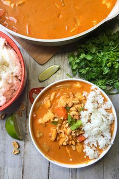 two bowls filled with different types of food on top of a wooden table next to rice