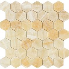 a white and beige hexagonal mosaic tile pattern with yellow marble tiles on it