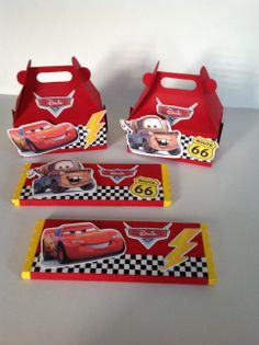 three boxes with cars on them sitting on a table