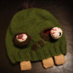 a green knitted hat with two holes in the middle