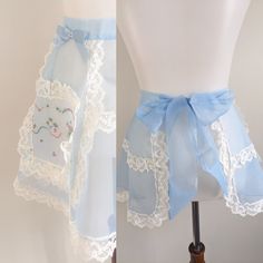 two pictures of the same skirt on a mannequin torso, one with a blue ribbon and the other with white lace