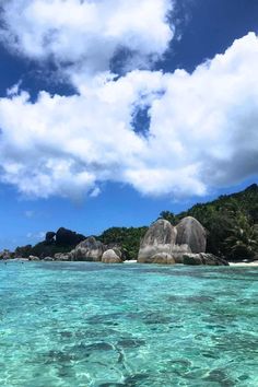 the water is crystal blue and clear with some rocks in it's foreground