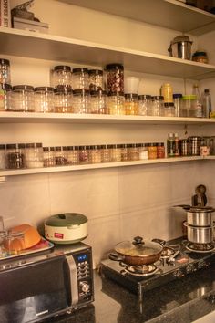 a kitchen with pots and pans on the shelves