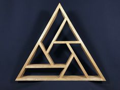 a wooden triangle shaped shelf on a black background