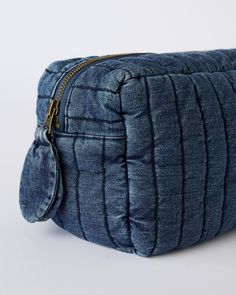 Rediscover our Heritage Denim, now in your favorite grab-and-go accessory. Made in organic cotton, the Quilted Denim Pouch was designed with a boxy shape to accommodate more of your on-the-go must-haves. Discover thoughtful details from the side handle to the antique brass zipper and subtle embroidered logo. Organic Cotton & Dyes Denim Pouch, Quilted Denim, Antique Brass, Light Fabric, Organic Cotton, Pouch, Brass, Zipper, Fabric