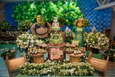 an arrangement of plants and decorations in front of a backdrop with characters from shrapberry's