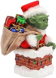 a christmas ornament with a bag full of presents in it's lap