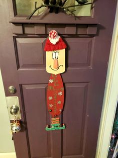 a door decorated with a christmas decoration and a cartoon character on it's side