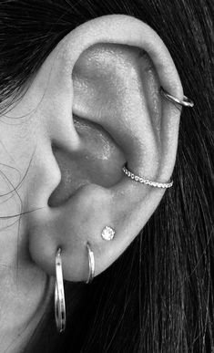 a close up of a person's ear with two piercings on the side