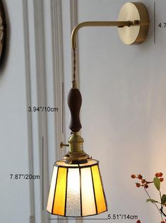 a wall mounted light with measurements for the bulb and shade on it's side