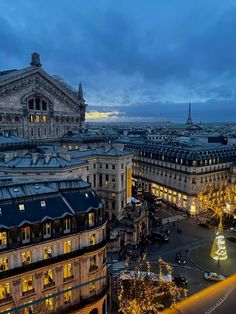 the city is lit up at night with christmas lights on it's trees and buildings