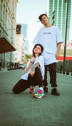 a man standing next to a woman on the street