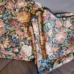 two pieces of fabric with flowers on them laying next to each other in a pile