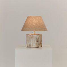 a lamp sitting on top of a white block