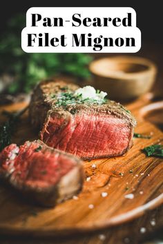 a steak on a wooden cutting board with parsley in the background and text overlay that reads pan - seared filet mig