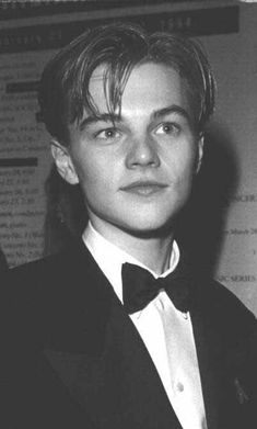 a young man wearing a tuxedo and bow tie