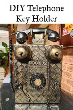 an old fashioned telephone sitting on top of a table with the words diy telephone key holder