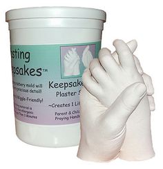 a white plastic hand next to a bucket of foamy gloves on a white background