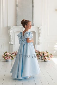 "A stunning flower girl dress with a train that boasts a large bow, a graceful V-neckline, and voluminous sleeves. This exquisite ball gown is perfect for any special occasion, whether it's a wedding, junior bridesmaid role, or a birthday celebration like a first birthday. The dress is adorned with elegant pearls, making it a charming pearl flower dress. Crafted from satin, this girl ball gown exudes timeless elegance and can even serve as a baby wedding dress. Choose this dress for an unforgettable birthday dress or a memorable bridesmaid dress. It's a versatile tutu girl dress with all the grace and style you desire This beautiful flower girl dress is perfect for a wedding, first communion, birthday, family photo shoot or any other occasion. See more flower girl dresses in my store: http Flower Girl Dresses Bow, Flower Girl Blue Dresses, Bridesmaid Dress Satin, Girls Ball Gown Dresses, Baby Wedding Dress, Kids Bridesmaid Dress, Blue Flower Girl Dress, Baby In Wedding Dress, Taffeta Bridesmaid Dress