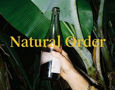 a person holding a bottle in their hand with the words natural order written on it