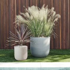 two cement planters sitting next to each other