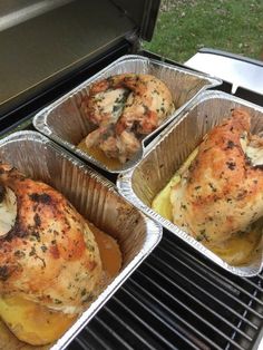 three pans filled with chicken sitting on top of an outdoor grill