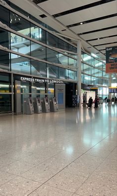 an airport terminal with luggage carts and people