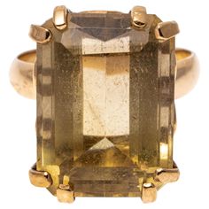 12k yellow gold ring. This handsome ring features a large emerald cut, pale light brown color smoky quartz, approximately 12.02 CTS, set with split prongs into a simple mounting with a scalloped gallery and high polished shank. Marks: None, tests 12k Dimensions: 1/2" wide x 5/8" long Weight: 4.2 gross dwt Yellow Gold Cocktail Ring, Light Brown Color, Mikimoto Pearls, Gold Cocktail Ring, Gold Cocktail, Yellow Citrine, Citrine Ring, Keshi Pearls, Lorde