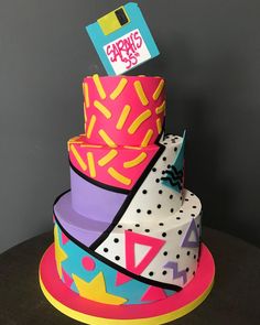 a multi - tiered cake decorated with colorful icing