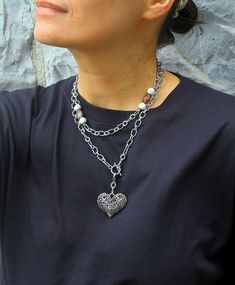 ♥ This long striking Silver Necklace with a toggle clasp and ivory jade beads is the perfect blend of modern elegance and bold design. The faceted jade and lilac glass beads offer a serene contrast to the textured silver chain, creating a stylish balance that's both eye-catching and sophisticated. A large heart pendant in the Victorian style complements the necklace and make it romantic and unique. The convenient toggle clasp adds a touch of charm while allowing for easy wear, making this neckla Dainty Heart Necklace, Boho Bar, Aesthetic Necklace, Necklace Aesthetic, Long Silver Necklace, Fancy Gifts, Necklace Long, Chunky Necklace, Jade Beads