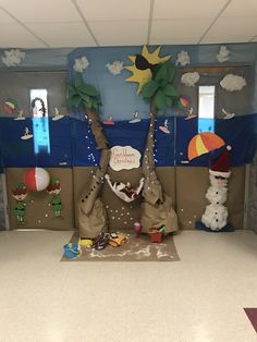 an office cubicle decorated for christmas with snowmen, santa hats and palm trees