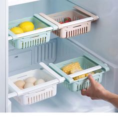 an open refrigerator with two shelves filled with fruits and vegetables, eggs and corn on the cob