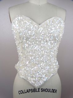 "ABSOLUTELY STUNNING vintage couture piece! It's completely hand sewn, fully embellished with iridescent beading, sequins and pearls. Measurements: Bust - 34\" Waist - 26\" Length - 14\" in the front and 9\" in the back (note, there is a zipper closure in the back going from top to bottom) All of my items come from a smoke-free and pet-free home. If you would like more info or have any questions, please don't hesitate to ask!" Wedding Corset With Sequins And Fitted Bodice, Glamorous Sequined Corset For Wedding, Sequin Sleeveless Fitted Bodice Corset, Glamorous Embellished Wedding Corset, Embellished Strapless Corset For Wedding, Embellished Strapless Wedding Corset, Strapless Embellished Wedding Corset, Glamorous Embellished Party Bodice, Fitted Sequin Wedding Corset