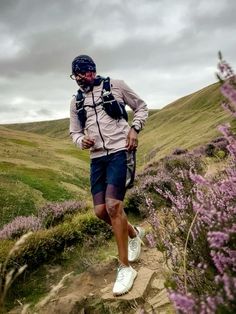 a man with a backpack walking up a hill