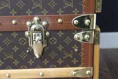 an antique louis vuitton trunk with brass rivets and studded handles