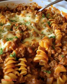 a close up of a plate of pasta with meat and cheese