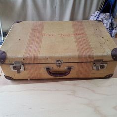 an old suitcase sitting on top of a table