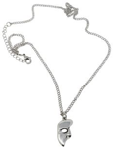 a silver necklace with an animal's head hanging from the chain on a white background