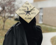 a woman wearing a graduation cap that says the plan is to fan this spark into a flame