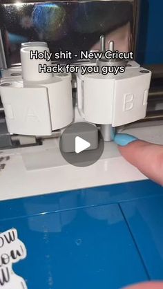 a person is pressing buttons on a sewing machine with their thumb and thumbnails