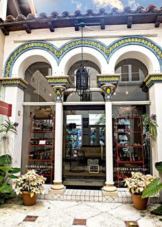 an entrance to a building with potted plants