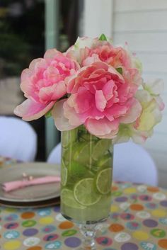 a vase filled with pink flowers sitting on top of a table