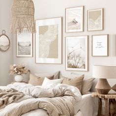 a white bedroom with pictures on the wall