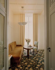 a living room with a couch, table and chairs