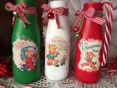 three christmas milk bottles are sitting on a table