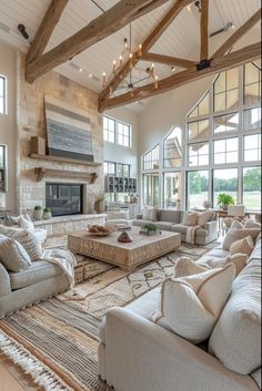 a large living room with couches and a fireplace