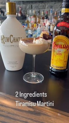 there are two ingredients in the martini on the bar and next to it is a bottle of rumchat