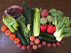 a table topped with lots of different types of fruits and vegetables on top of each other