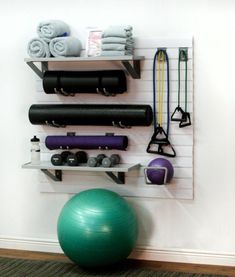 there is a gym ball, exercise equipment and other items on the wall