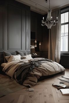 a large bed sitting next to a window in a room with dark walls and wooden floors